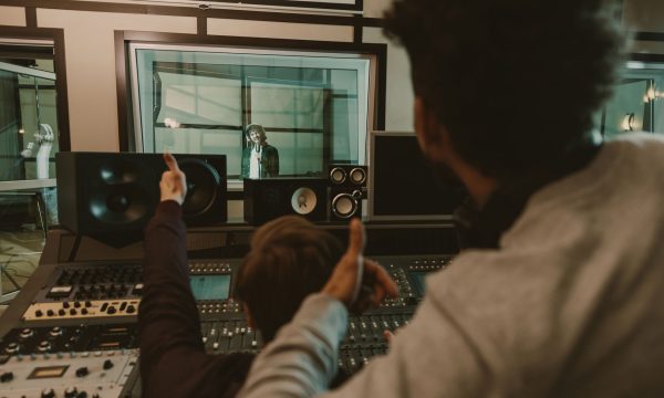 sound producers showing thumbs up to singer at recording studio sound producers showing thumbs up to singer at recording studio